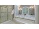 Bathroom featuring a luxurious soaking tub and walk-in shower with glass doors at 4310 Granby Way, Marietta, GA 30062