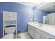 Clean bathroom featuring blue walls, white cabinets, and white tile floor at 4310 Granby Way, Marietta, GA 30062
