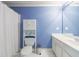 Fresh bathroom featuring blue walls, white cabinets, and white tile floor at 4310 Granby Way, Marietta, GA 30062