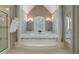 Bathroom with a luxurious soaking tub flanked by columns and a glass shower at 4310 Granby Way, Marietta, GA 30062