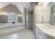 Bathroom featuring a luxurious soaking tub, vanity and a walk-in shower at 4310 Granby Way, Marietta, GA 30062