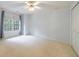 Bedroom with a ceiling fan, large window, neutral carpet, and a closet with white doors at 4310 Granby Way, Marietta, GA 30062