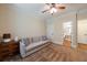 Bedroom with a tan sofa, soft carpet, ceiling fan, and a view into an attached bathroom at 4310 Granby Way, Marietta, GA 30062