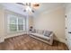 Bedroom featuring a tan sofa, soft carpet, ceiling fan, and natural light from a window at 4310 Granby Way, Marietta, GA 30062