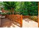 Wood deck with wooden railings, surrounded by mature trees, provides an inviting outdoor living space at 4310 Granby Way, Marietta, GA 30062