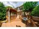 Exterior view of home showcasing a deck with a grill and steps, leading to a screened porch at 4310 Granby Way, Marietta, GA 30062
