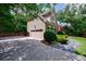Home exterior showcasing an attached garage and a meticulously landscaped front yard at 4310 Granby Way, Marietta, GA 30062