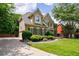 Exterior view features lush landscaping, a well-manicured lawn, and a circular driveway at 4310 Granby Way, Marietta, GA 30062