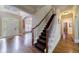 Inviting foyer with hardwood floors, a carpeted staircase, and white front door at 4310 Granby Way, Marietta, GA 30062