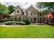 Elegant two-story home featuring a manicured lawn and a stone walkway leading to the front entrance at 4310 Granby Way, Marietta, GA 30062
