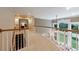 Upstairs hallway with wood banisters and trim, cream-colored carpeting, and light from the two-story windows at 4310 Granby Way, Marietta, GA 30062