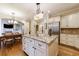 Bright kitchen island boasts granite countertops, custom cabinets, and stainless appliances at 4310 Granby Way, Marietta, GA 30062