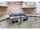 Gourmet kitchen boasts stainless KitchenAid appliances, granite counters, and custom cabinetry at 4310 Granby Way, Marietta, GA 30062