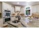 Gourmet kitchen with granite counters, stainless steel appliances and a large window for natural light at 4310 Granby Way, Marietta, GA 30062