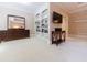 Upstairs living room with built-in bookshelves, a wall-mounted television, and a dark wood dresser at 4310 Granby Way, Marietta, GA 30062