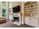 Bright living room features built-in shelving, a fireplace with mantle, and views of the yard at 4310 Granby Way, Marietta, GA 30062