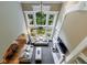 Two-story living room with large windows, a fireplace, a ceiling fan, and hardwood floors at 4310 Granby Way, Marietta, GA 30062