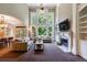 Spacious living room with soaring ceilings, built-in bookshelves, a fireplace, and large windows at 4310 Granby Way, Marietta, GA 30062