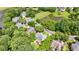 Aerial view showcasing a home nestled within a lush, wooded neighborhood with ponds and mature trees at 4310 Granby Way, Marietta, GA 30062