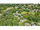 Aerial view featuring a neighborhood with mature trees surrounding homes with ponds at 4310 Granby Way, Marietta, GA 30062