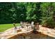 Stone patio with outdoor seating, ideal for relaxing and enjoying the surrounding lush greenery at 4310 Granby Way, Marietta, GA 30062
