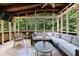 Inviting sunroom features comfortable seating, a ceiling fan, and serene views of the lush surrounding greenery at 4310 Granby Way, Marietta, GA 30062