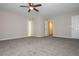 Spacious bedroom with neutral carpet and a ceiling fan at 10980 Pinehigh Dr, Alpharetta, GA 30022