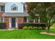 Well-maintained home with a manicured lawn, flowering bushes, and a charming front entrance at 10980 Pinehigh Dr, Alpharetta, GA 30022