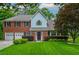 Charming two-story brick home with a well-manicured lawn and a two car garage at 10980 Pinehigh Dr, Alpharetta, GA 30022
