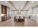 Spacious kitchen featuring wood beams, a large island with seating, pendant lighting, and stainless steel appliances at 113 Laurel Brook Ln, Canton, GA 30115