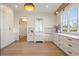 Bright kitchen with white cabinets, marble countertops, and farmhouse sink at 113 Laurel Brook Ln, Canton, GA 30115