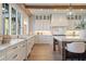 Bright kitchen featuring custom white cabinets, marble countertops, stainless steel appliances, and wood beam accents at 113 Laurel Brook Ln, Canton, GA 30115
