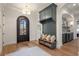 Inviting mudroom with custom cabinets, bench seating, and arched doorway at 113 Laurel Brook Ln, Canton, GA 30115