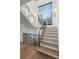 Open staircase featuring wood treads, black metal railings, large windows, and stylish lighting fixtures at 113 Laurel Brook Ln, Canton, GA 30115