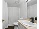 This bathroom features a toilet, shower with curtain, vanity with sink and a large mirror at 1271 Muirforest Ln, Stone Mountain, GA 30088