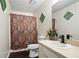 Cozy bathroom featuring animal print shower curtain, neutral walls, and a patterned mirror at 1271 Muirforest Ln, Stone Mountain, GA 30088