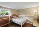 Neutral bedroom with dark wood flooring, a large window, and simple decor at 1271 Muirforest Ln, Stone Mountain, GA 30088