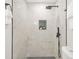 Modern shower with white tile surround, black fixtures, and niche for toiletries at 1675 White Oak Way, Decatur, GA 30032