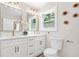 Modern bathroom boasts double vanity, white cabinets, gold hardware, and modern fixtures, offering a luxurious feel at 1675 White Oak Way, Decatur, GA 30032