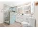 Stylish bathroom featuring dual vanities, sleek white cabinetry, marble-look walk-in shower, and modern fixtures at 1675 White Oak Way, Decatur, GA 30032