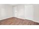 Bedroom featuring wood-look floors, white trim, doors and neutral walls at 1675 White Oak Way, Decatur, GA 30032