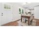 Bright dining area features wood floors, white walls, table with seating for four, and a view into the kitchen at 1675 White Oak Way, Decatur, GA 30032