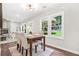Inviting dining area with ample natural light, seamlessly connected to the living room, creating an ideal space for Gathering meals at 1675 White Oak Way, Decatur, GA 30032