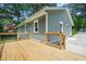 Back of home showing the wooden deck, light green siding, and well maintained landscaping at 1675 White Oak Way, Decatur, GA 30032