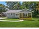 Charming home featuring a covered porch, well-kept lawn, and classic design with a modern exterior paint and ample natural light at 1675 White Oak Way, Decatur, GA 30032