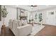 Bright living room with an electric fireplace, wood floors, stylish furniture, and white walls, creating a serene and inviting atmosphere at 1675 White Oak Way, Decatur, GA 30032