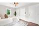 A tranquil main bedroom features a ceiling fan, natural light, and a soft queen bed on a patterned rug at 1675 White Oak Way, Decatur, GA 30032