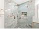 Contemporary walk-in shower showcasing marble-look tiles, sleek fixtures, and a convenient built-in niche at 1675 White Oak Way, Decatur, GA 30032