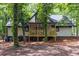 Home featuring backyard deck and lush landscaping at 6486 Aquila Dr, Morrow, GA 30260
