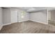 Unfinished basement featuring grey walls, white trim, and wood-style flooring at 6486 Aquila Dr, Morrow, GA 30260